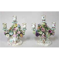 A pair of candelabras porcelain, Meissen, h 21 cm; damaged 4.000-6.000...