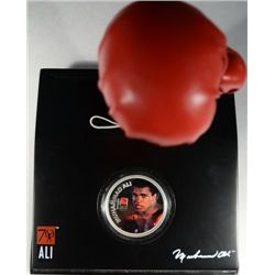 ALI 1 oz. painted silver round in stand with a boxing glove