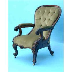 A Victorian mahogany spoon back armchair with scroll arms on acute cabriole legs upholstered in d...