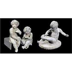 An early 20th century lead figure of a seated child tugging at his sock, on oval base, 23cm high (9i