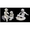 Image 1 : An early 20th century lead figure of a seated child tugging at his sock, on oval base, 23cm high (9i