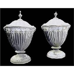A pair of early 19th century lead urns and covers, the part fluted urns applied with swag moulding a