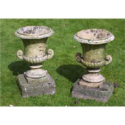 A pair of stoneware two-handled urns, of semi-lobed campana form with everted rim and scrolling lobe