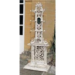 A mid 19th century cast iron hall stand, the back pierced all over with stylised leaves and berries,