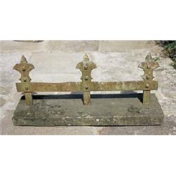 A cast iron bootscraper, the three upright supports with fleur-de-lys terminals, on sandstone base,.