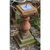 Image 1 : A terracotta balustrade, on square base, mounted with a lead sundial, the plate engraved with a sun.