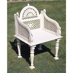 A white marble seat, the arched back carved with a sunburst above a pierced panel, the downswept sid
