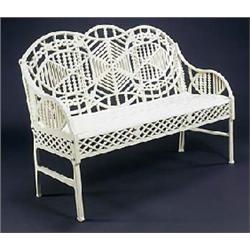 An early 20th century cast iron bench, the shaped back and down-swept arms pierced with geometric pa