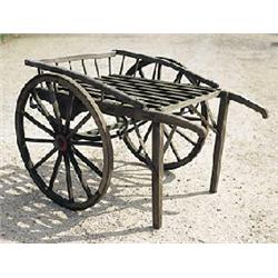 An oak two wheeled market trader's barrow with sprung cradle and cast iron bound wheels £200-300...