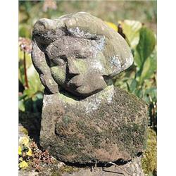 A red sandstone bust of a girl, the naively carved figure with closed eyes and face down turned on r