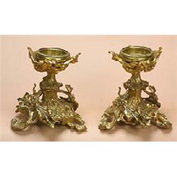 A pair of 19th century French gilt metal stands in rococo style, each with a later round recessed to