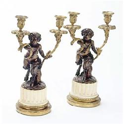 A pair of mid 19th century French bronze candelabra, after Clodion, each in the form of a faun, supp