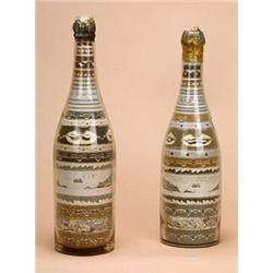 A pair of mid 19th century sand filled glass bottles, with horizontal bands of geometric patterns an