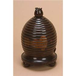 A mid 19th century lignum vitae string box, in the form of a bee hive, the turned finial with a rece