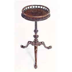 A George III mahogany kettle stand, the round top with a turned spindle gallery, on a spirally flute