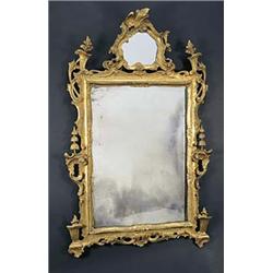 An Italian giltwood mirror in mid 18th century style, the mirrored crest as a cartouche, the frame c