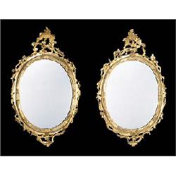 A pair of 19th century giltwood wall mirrors, each mahogany frame with an acanthus crest and scrolls