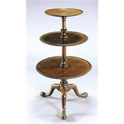 A George III mahogany dumb waiter, the three dished graduated tiers with baluster and spirally flute