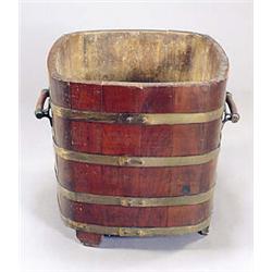 A walnut log bin of rectangular coopered form with brass bands, two handles and block feet, 52 high.