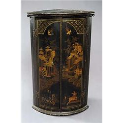 An early 19th century japanned bowfronted hanging corner cupboard, with moulded cornice above two do