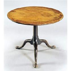 A George III mahogany tilt top table, the round top on a turned column and tripod base with pad feet