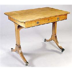 An early 19th century mahogany and ebony strung rectangular library table, the top with rounded corn