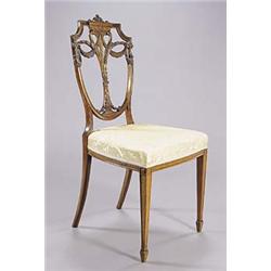 A late 19th century satinwood Sheraton revival side chair, the shield shaped back interlaced and car