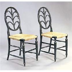 A pair of mid 19th century ebonised side chairs, each painted in red and green with flowers, each wi