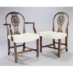 A set of eight mahogany dining chairs in George III style, each with a hoop back and patera carved a