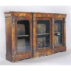 A Victorian walnut breakfront bookcase, the top with a moulded edge above a floral marquetry frieze,