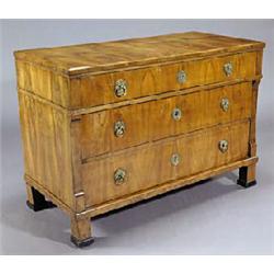 An early 19th century Scandinavian walnut commode, with three long drawers, the upper drawer outset,