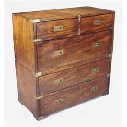 A mid 19th century teak military chest, with brass bindings, in two sections with two short and one.