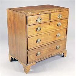 An early 19th century mahogany chest, the crossbanded flush top above two short and three long gradu