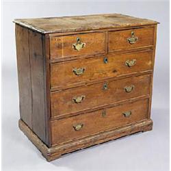 A George III oak chest, the top with a moulded edge above two short and three long drawers with late