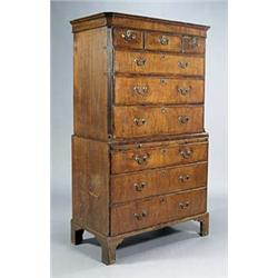 A George II walnut crossbanded chest on chest, the concave cornice above three short and three long.