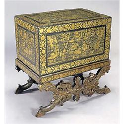 An early 19th century Eastern chest on stand, painted overall in gilt with figures in landscapes wit