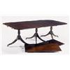 Image 1 : A mahogany three pillar dining table in Regency style with two loose leaves, the top with rounded co