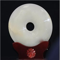 ROUND JADE STATUE WITH ANTIQUE WOOD BASE.