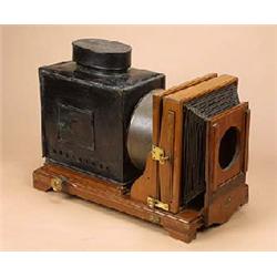 A large mahogany and japanned tinplate magic lantern, with tilt facility and brass knob adjustments.