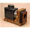 Image 1 : A large mahogany and japanned tinplate magic lantern, with tilt facility and brass knob adjustments.