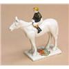 A Carlton model of a racehorse,  the jockey with black and brown boots, ochre cap, and wearing black