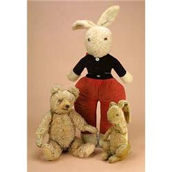 A teddy bear and two rabbits: comprising a 1920s teddy with fully-jointed golden plush body and blac