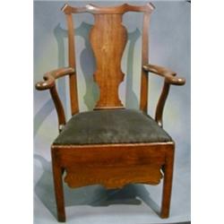 A Georgian Country oak splat back commode chair with drop in seat (no china liner) raised on square