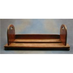 A 19th Century mahogany expanding book trough raised on bun supports 30 