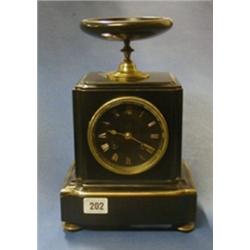 A French 19th Century 8 day striking mantel clock striking on a bell, contained in a black