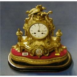 A French 19th Century 8 day striking mantel clock with enamelled dial and Roman numerals contained