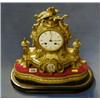 Image 1 : A French 19th Century 8 day striking mantel clock with enamelled dial and Roman numerals contained