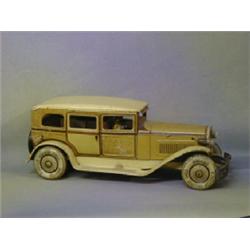 A 1920's clockwork model of a limousine with battery operated lights by TC, 14 