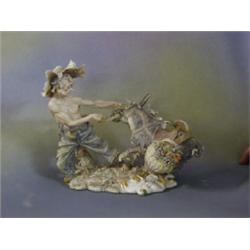 A Capo di Monte biscuit porcelain figure of a man with struggling with a laden donkey 10" £20-40534