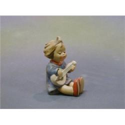 A Goebal figure of a seated girl with banjo, the base marked 53 Goebal Germany